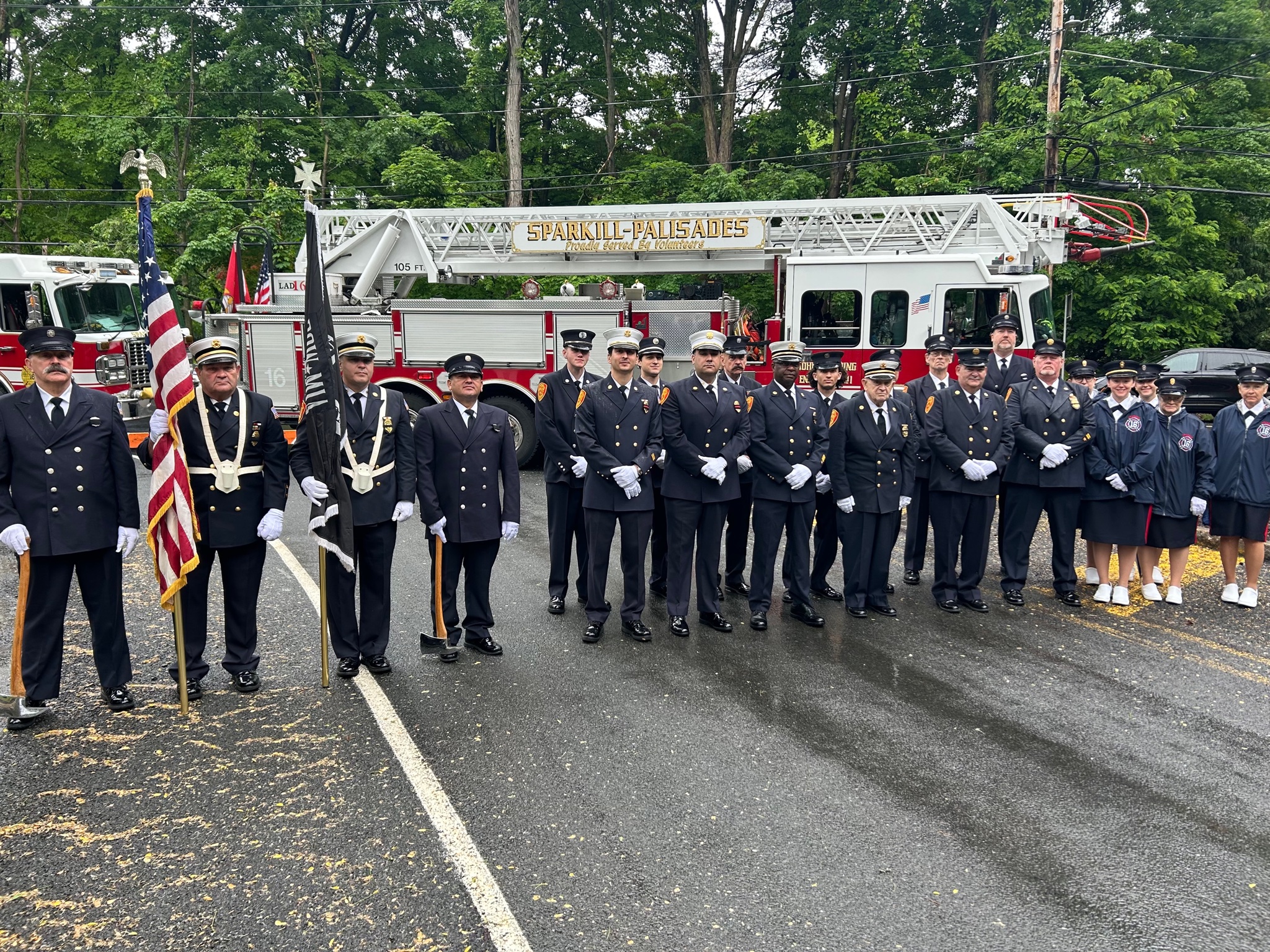 Full department in Class-A dress uniform inspection in front of the Sparkill-Palisades 105ft ladder truck